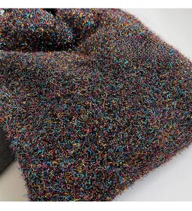 Macro shot of colorful metallic thread knit fabric with long faux fur texture and sparkle