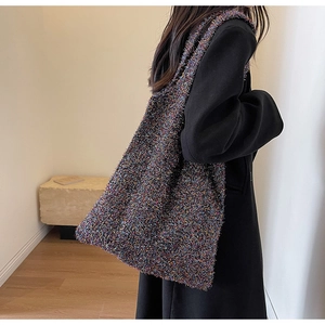 Detailed view of the colorful tweed texture and spacious design of the knit shoulder bag