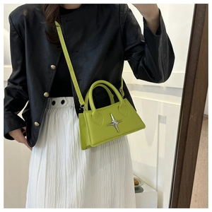 Detail of fruit green mini crossbody bag with silver star ornament and long strap