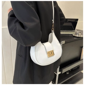 White semi-circular saddle bag shown on shoulder with golden buckle and sleek matte finish