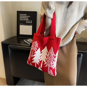 Detailed close-up of red knit tote bag featuring white cedar tree patterns for winter