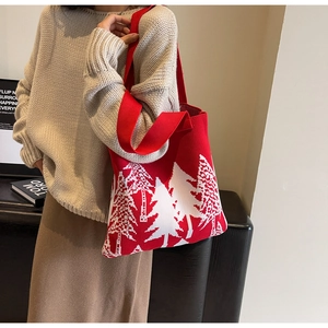 Close-up of red and white knitted tote bag with festive Christmas tree patterns