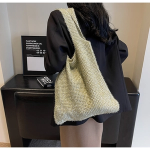 Detail of glitter knit tote bag in champagne gold showing texture and slouchy drape
