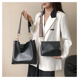 Detail of black leather tote and crossbody bag set with geometric woven strap and chain handles