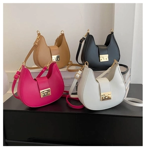 Detail view of multi-color PU leather saddle bags with gold metal clasps in four colors