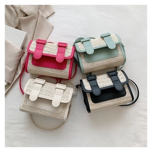 Detail showing four straw-woven crossbody bags in pink, green, white, and black colors
