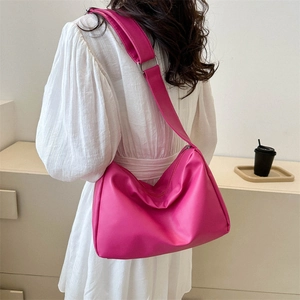 Minimalist soft leather hobo bag in rose red color with a stylish slouchy texture