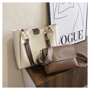 Off-white tote with gold chain details paired with a geometric strap crossbody bag