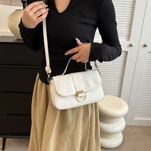 Elegant white faux leather crossbody bag with gold buckle on a minimalist background