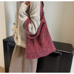 Close-up of red glitter knit tote bag showing soft texture and sparkly silver thread details