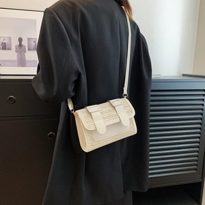 Elegant beige straw and PU leather crossbody bag with flap and decorative buckle straps