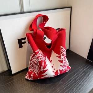 Winter knit tote bag with festive red and white Christmas tree pattern on wood surface