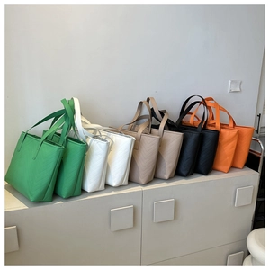 Detail of multi-color tote bags set featuring elegant V-shaped quilted stitching