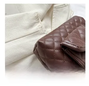 Detailed macro view of the brown quilted leather tote with elegant diamond stitching