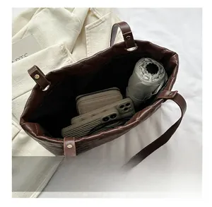 Macro view of the large quilted tote bag interior showing capacity for daily essentials