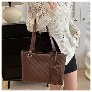 Deep brown quilted tote bag with matching coin purse shown in a lifestyle home setting
