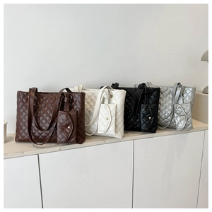 Quilted tote bags with matching pouches in brown, beige, black, and silver grey finishes