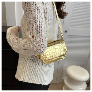 Detail of gold crocodile embossed leather texture with Fashion & Bags logo engraving