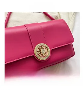 Detail of rose red leather texture and ornate gold metal buckle with inset crystal