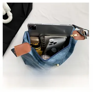 Draufsicht auf das Innere der blauen Denim-Tasche mit Platz für Tablet und Regenschirm