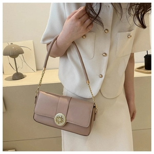Detail of lavender flap crossbody bag featuring a golden circular clasp and chain strap