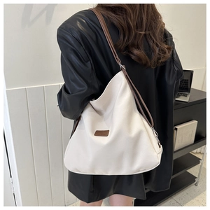 Detailed back view of off-white Hobo shoulder bag showing large capacity and brown strap
