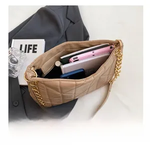 Interior view of quilted beige shoulder bag showing capacity for tablets and notebooks