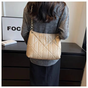 Model view of beige quilted faux leather shoulder bag with golden chain strap for daily wear