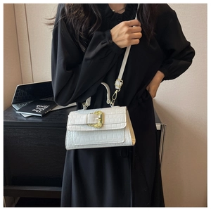 Detail of white crocodile pattern bag with vintage baroque gold buckle and shoulder strap