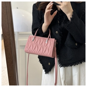 Pink Matelassé pleated faux leather handbag with metal link handles and a shoulder strap