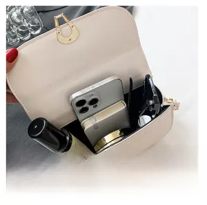 Vista interna della borsa a tracolla beige coccodrillo con spazio per oggetti quotidiani