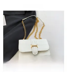 Close-up of white crocodile pattern shoulder bag with elegant gold chain strap and buckle