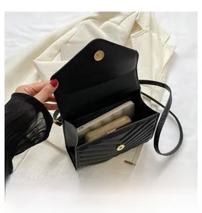 Detailed interior view of quilted black crossbody bag showing phone and wallet storage