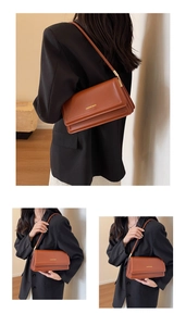 Detail of caramel shoulder bag with accordion sides and gold Fashion Bags lettering