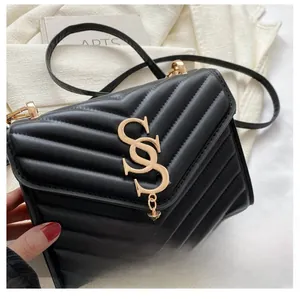 Detail of V-quilted black leather bag with a gold metal SS logo and elegant chain strap