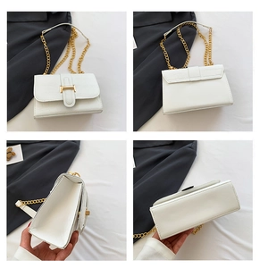 Detail view of white crocodile pattern shoulder bag with gold chain and metal clasp