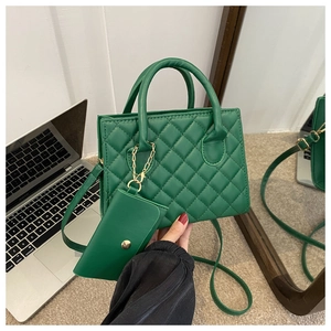 Green quilted handbag with matching mini pouch and chain shown in a lifestyle daily setting