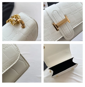 Close-up of white crocodile pattern bag featuring gold H buckle and chain strap detail
