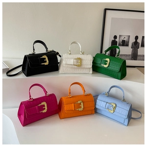 Detailed view of six crocodile-embossed mini square bags with vintage gold buckles