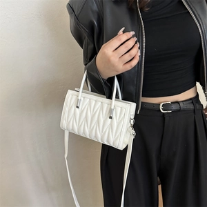 Chic white V-quilted faux leather handbag with silver hardware and shoulder strap