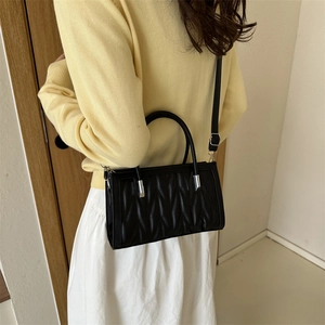 Quilted black faux leather satchel bag with silver top handles for stylish commuting