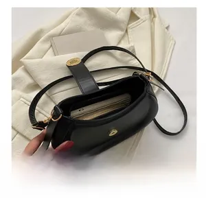 Interior view showing the large storage capacity for phone and wallet in a black saddle bag