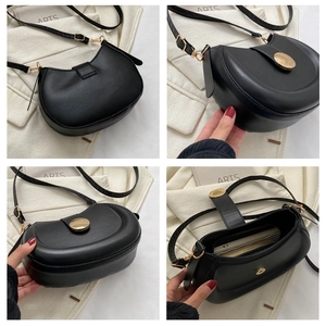 Detailed interior of black saddle bag showing capacity for phone and wallet with zipper pocket