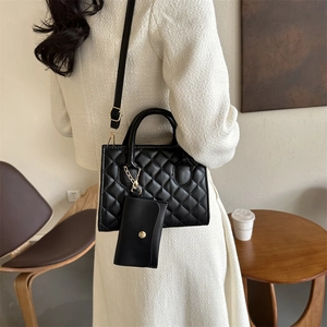 Elegant black quilted handbag set with gold hardware and a matching small pouch