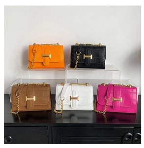 Miniature flap bags in five colors with faux crocodile texture and gold H metal clasps