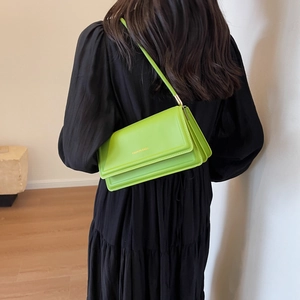 Neon green rectangular crossbody bag with Fashion Bags print shown on a model