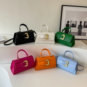 Crocodile texture handbags in multiple colors with golden baroque buckles on displays