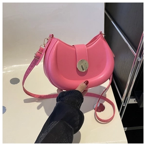 Detailed view of pink moon-shaped saddle bag featuring a smooth PU leather finish and buckle