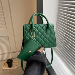 Deep green quilted crossbody bag with diamond patterns and mini pouch pendant charm