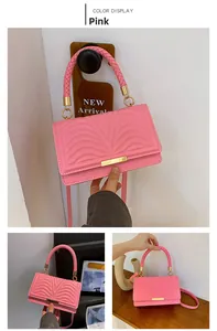 Pink quilted crossbody bag with V-shaped texture and gold metal buckle detail